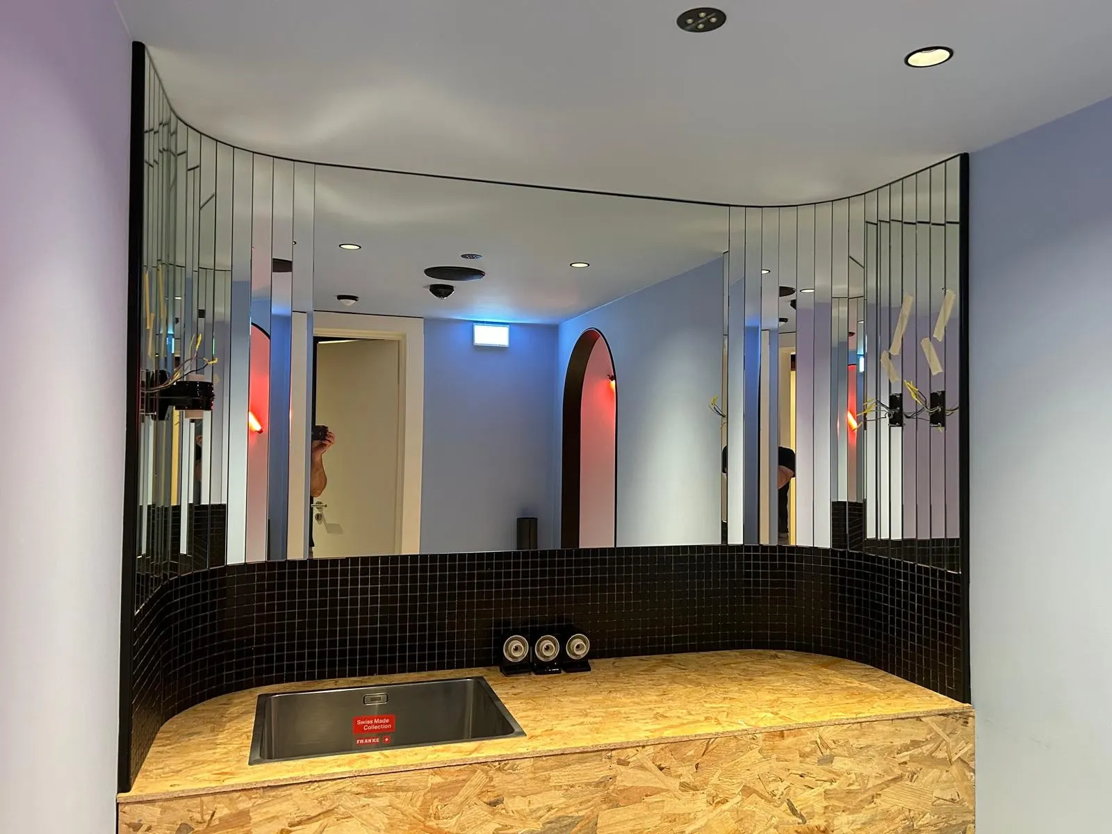 Miroir décoratif sur mesure en bandes courbées au-dessus d'un lavabo — réalisation Vitralux Luxembourg